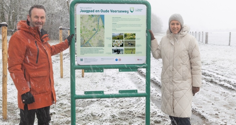 Anita Pijpelink en Rob van Westrienen in de sneeuw bij bord Natuurgebied Jaagpad en Oude Veerseweg. Beeld Marcel Klootwijk