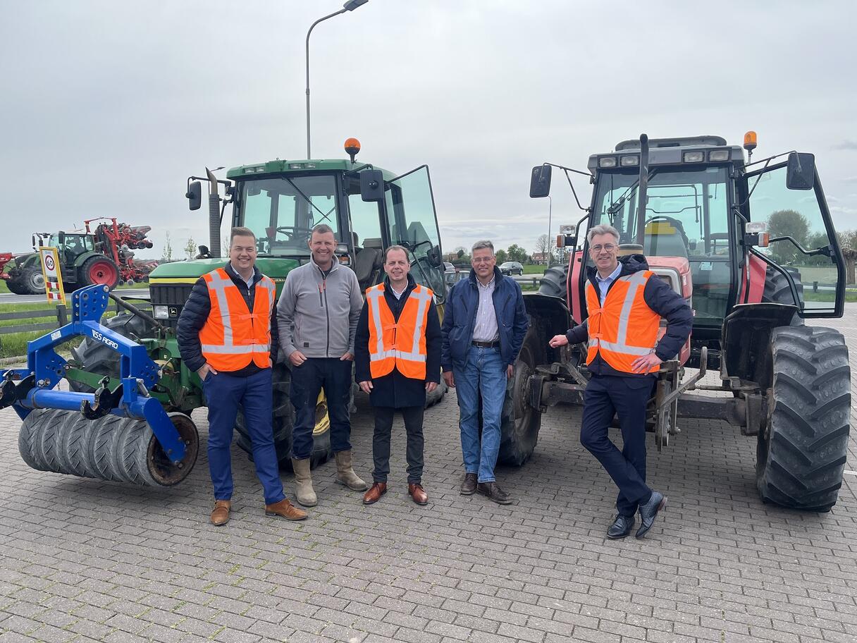 Gedeputeerde Van der Maas samen wethouders Meulblok en Van Belzen en mensen van ZLTO bij twee tractoren