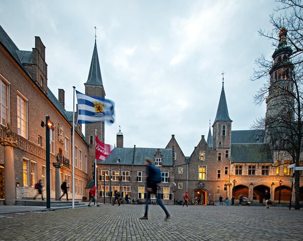 Lopend over abdijplein naar ingang Provinciehuis