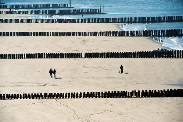 Mensen wandelen over het strand van Westkapelle.